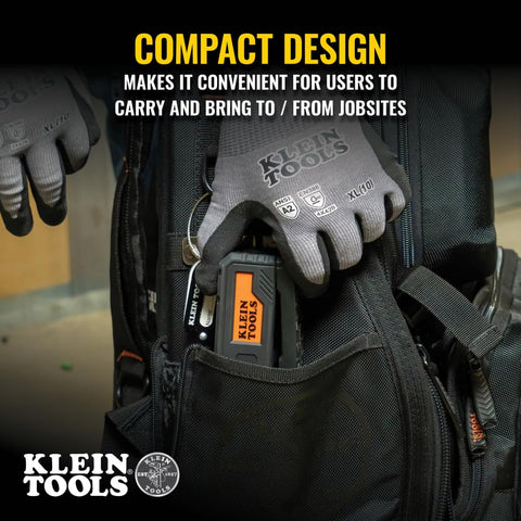 Person placing Magnetic Pocket Laser Level With 360 Degree Wall Attachment into a tool bag, showcasing compact design.