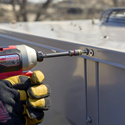 Person using Cleanable Reversible 4 Inch Magnetic Hex Chuck Driver With Dual Sided Magnetic Hex Bit to fasten metal panel.
