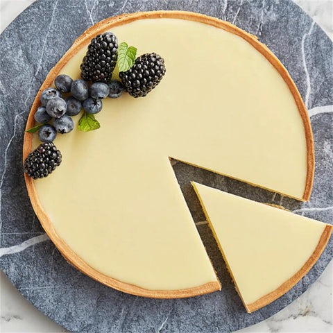 Sliced tart topped with berries made using Creamy White Chocolate Baking Bar With Real Dairy And Cocoa Butter, Bean To Bar Craft