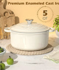 Cream White Enameled Cast Iron Dutch Oven 5 Quart With Lid And Cotton Potholders on kitchen counter