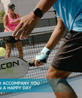 Ultra Thin Pickleball And Tennis Wrist Brace with Adjustable Compression on player during match, black left hand