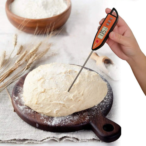 Hand using Instant Read Meat And Milk Thermometer With Probe Holds Temperature Celsius Fahrenheit Toggle Auto Off After 10 Minutes And Clear LCD For Cooking BBQ Grilling Deep Fry Roasting And Baking to measure dough temperature.