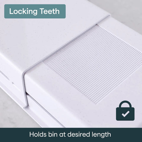 Close-up of locking teeth feature on Expandable Sliding Drawer Bin For Kitchens Sets The Bar Inside Deep Drawers in speckled white.