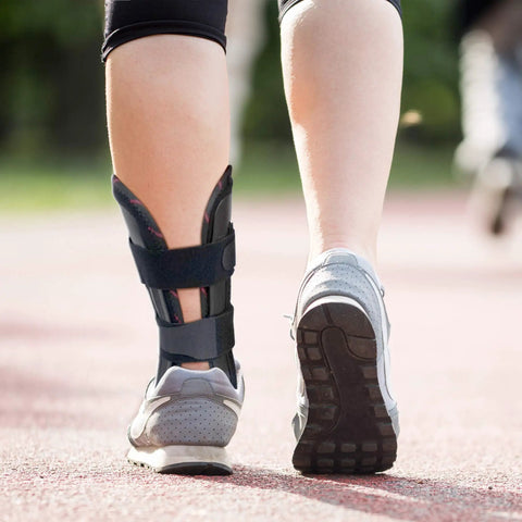 Person wearing All Day Ankle Stabilizer Brace With Stirrup Support For Foot Injuries Tendonitis And Chronic Ankle Instability