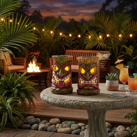 Tiki Head Garden Decor With Solar Outdoor Light Set Of 2 Tropical Hawaiian Resin Yard Sculptures on patio table at night