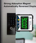Digital inclinometer with strong magnet and reversed display attached to a metallic surface, for precise angle measurements.
