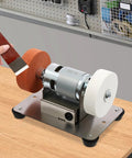 Heavy Duty Mini Belt Sander, Kickass Electric Benchtop Grinder With Dual Coarse And Fine Wheels, Fast Variable Speed Control, user grinding a tool.