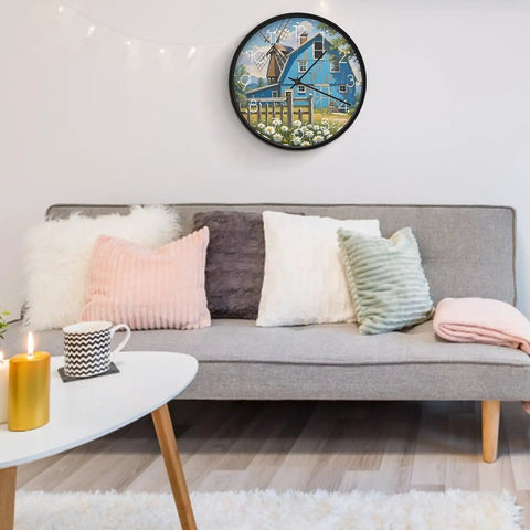 Dead Quiet Sweep Wall Clock With A Sweet Rural Blue Valley Warehouse Vibe Non Ticking Round Timepiece on wall above grey sofa.