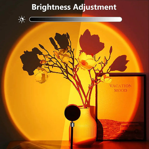 Sunset Lamp With 16 Color Modes And Remote Control Lit Night Light creating orange ambiance on flowers and decor