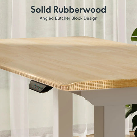 Premium Four Leg Height Adjustable Standing Desk With Natural Maple Surface And Rock Solid Anti Wobble Engineering For No Stress Home Office And Multi Monitor Setups close-up of rubberwood surface with angled design and adjustment controls