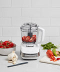Core Custom 4 Cup Mini Chopper and Food Processor with tomatoes in bowl, auto reversing stainless steel SmartPower blade, white and stainless design
