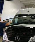 Technician using One Person Windshield Setting Tool For Auto Glass Installation Kit With Suction Cups on van windshield.