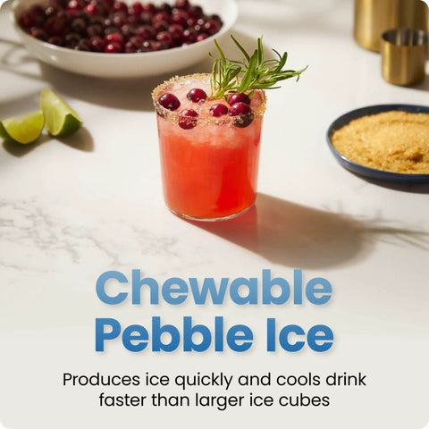 Glass with drink, garnished with cranberries and rosemary, highlighting Compact Pebble Ice Maker For Countertop