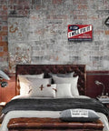 Vintage Metal Man Cave Sign For Men If I Say I Will Fix It There Is No Need To Remind Me Every 6 Months Funny Garage Wall Decor For Workshop Basement And Home Bar 12 X 8 Inches displayed on a brick wall above a bed in a bedroom setting.