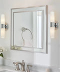 Dual 14 Inch Modern Wall Sconce With Frosted Glass Cylinder Shades In Chrome Finish next to bathroom mirror