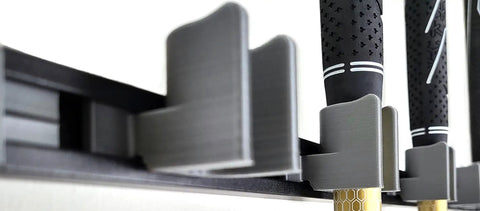 Close-up of golf club grips in soft-contact holders on a Golf Club Wall Mount Rack For Garage And Golf Room, Organizes 17 Clubs On 36 Inch Aluminum Display.