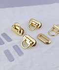 Gold turn-lock purse clasps with rings, 4-piece set, for DIY handbags; includes lavender strap slides.