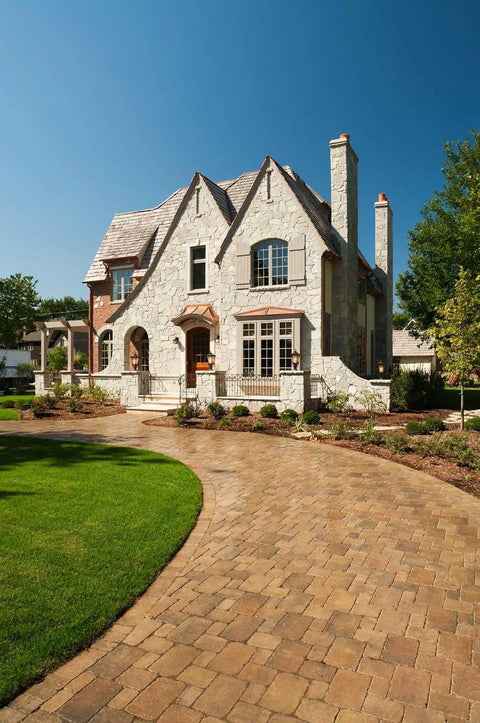 Real Deal Wet Look High Gloss Concrete And Paver Sealer For Exterior Patios featuring five gallon container near paved driveway.