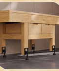Heavy Duty Adjustable Furniture Leveling Feet L Shaped Leg Levelers 24 Pack Black installed under wooden desk.