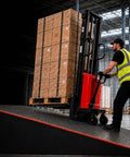 Worker using 3300 LB Capacity Semi Electric Stacker And Compact Pallet Jack That Slips Into Tight Warehouse Spaces Like A Dream on ramp.