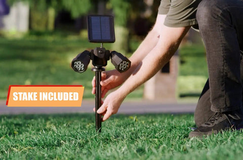 Person installing Solar Motion Sensor Outdoor Lights With Adjustable Heads And Ultra Bright LEDs For Yard Patio And Garden