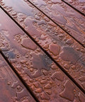 Heavy Duty Liquid Waterproofing Membrane Multi Surface Crack And Leak Repair Coating Interior Exterior Water Based Moisture Blocker Heavy Duty Sealant Easy Brush Application 5 Gallon Sandy Beige on wood surface with water droplets.