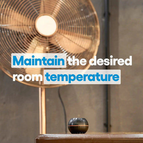 HT Black WiFi Temperature And Humidity Sensor For Smart Home Automation in front of a fan, displaying room temperature.