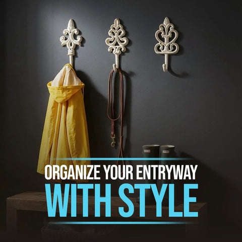 Distressed White Cast Iron Wall Hooks Set Of Three with a yellow coat and leashes hanging on a dark wall.