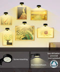 Smooth Dimming Battery Operated Picture Light With Remote Control For Wall Art Posters Frames illuminating framed artwork on a wall.