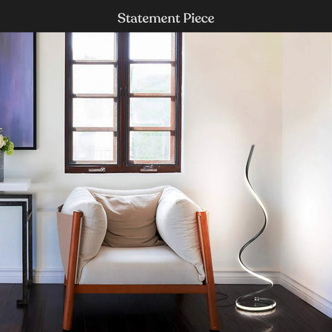 Dope 37 Inch LED Spiral Floor Lamp With Curved Modern Design next to armchair in living room, jet black, dimmable lighting.