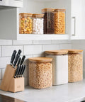 Two Pack 3.6 Qt Square Glass Food Storage Jars With Lids A Kitchen Must Have For Flour Sugar Rice Pasta Oats Coffee Beans Keeps Your Pantry Organized And Fresh Clear See Through Design on a counter.
