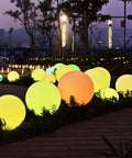 Dope 6 Inch Floating Pool Light LED Ball With Remote Control Rechargeable Battery And 16 RGB Colors glowing in a park at night