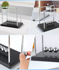 Large Newtons Cradle Pendulum Desk Toy With 5 Beads Perpetual Motion Balance Balls Black Wooden Base shown on office desk