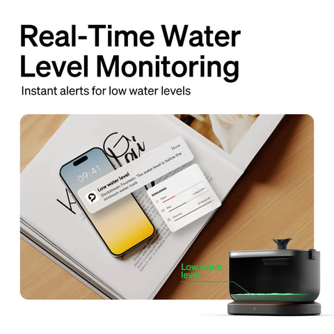 Smart Cat Water Fountain With App Monitoring And Stainless Steel Tray next to phone displaying low water alerts.