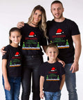Family wearing matching Christmas T-shirts with festive design