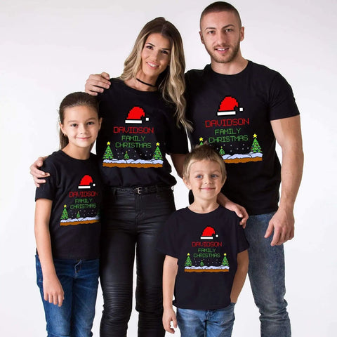 Family wearing matching Christmas T-shirts with festive design
