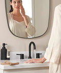 Precept Widespread Matte Black Bathroom Faucet For 3-Hole 6-16 In. Install With ADA Push Pop-Up Drain on a white counter