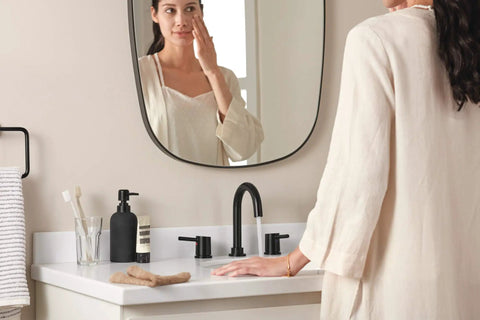 Precept Widespread Matte Black Bathroom Faucet For 3-Hole 6-16 In. Install With ADA Push Pop-Up Drain on a white counter