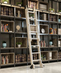 Rock Solid Steel Roller Track Roll Out Smooth For Library Ladder And Barn Doors, showing steel ladder against modern shelves.