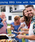 Family enjoying BBQ outside with man grilling at summer gathering