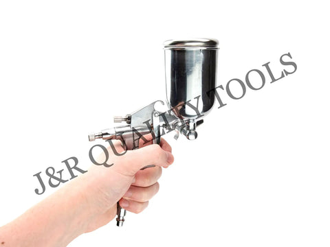 Slick Compact Spray Gun Airbrush Kit With A Hella Precise 0.5mm Nozzle And Super Comfy Ergonomic Trigger For Flawless Detail Painting And Crafts, held in hand.
