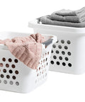30L Plastic Laundry Hamper With Built In Comfort Carry Handles 2 Pack Nestable Ventilated Clothes Basket in white filled with clothes