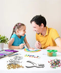 Father and daughter crafting at a table with 200 Piece Colorful Mini Paper Brads With Silver Washers And Hole Punch Pliers Set