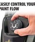 Hand adjusting the paint flow control on the Heavy Duty Mobile Airless Paint And Stain Sprayer Cart for precise application.