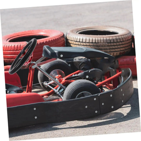 Universal 14 Inch PU Racing Steering Wheel With Horn Button Red Drift Wheel on a go-kart track with tire barriers.