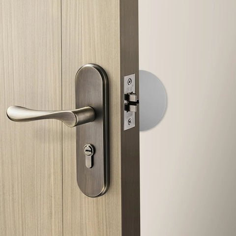 Gray Silicone Door Handle Buffer Guards 4 Pack Self Adhesive Wall Protectors installed behind a wooden door handle