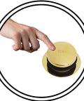 Close-up of hand pressing push button on Top Tier Universal Bathtub Drain Plug Set Featuring Slick Polished Brass Finish.