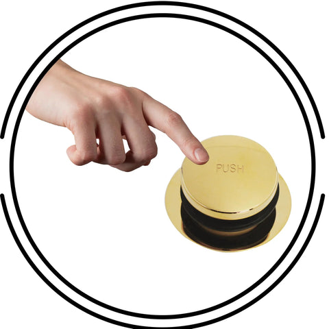 Close-up of hand pressing push button on Top Tier Universal Bathtub Drain Plug Set Featuring Slick Polished Brass Finish.