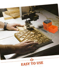 Person using 37 Piece Metal Stamping Kit With Letter And Number Punches Plus Heart Symbols For DIY Jewelry Making Wood Plastic And Craft Projects