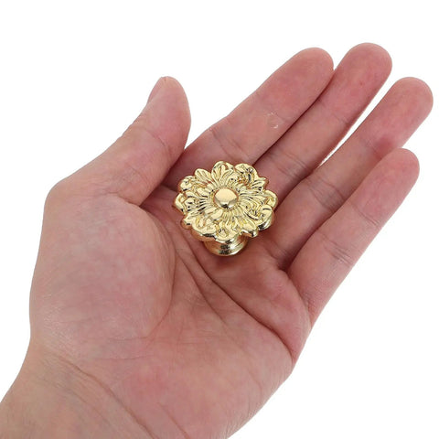 Hand holding Antique Zinc Alloy Drawer Pulls for Dresser and Cabinets, Old School Floral Handles with Solid Build and Easy One Hole Install